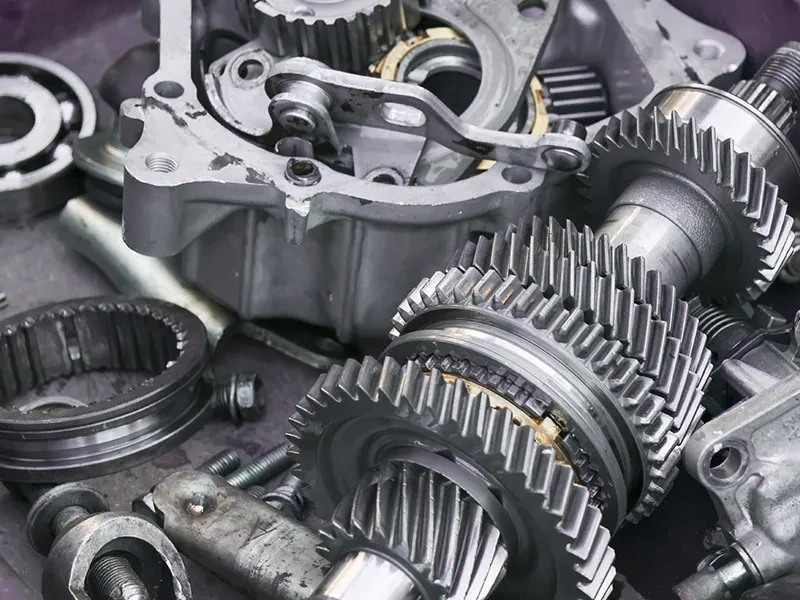 Industrial gears and mechanical components illustrating manufacturing scrap and rework