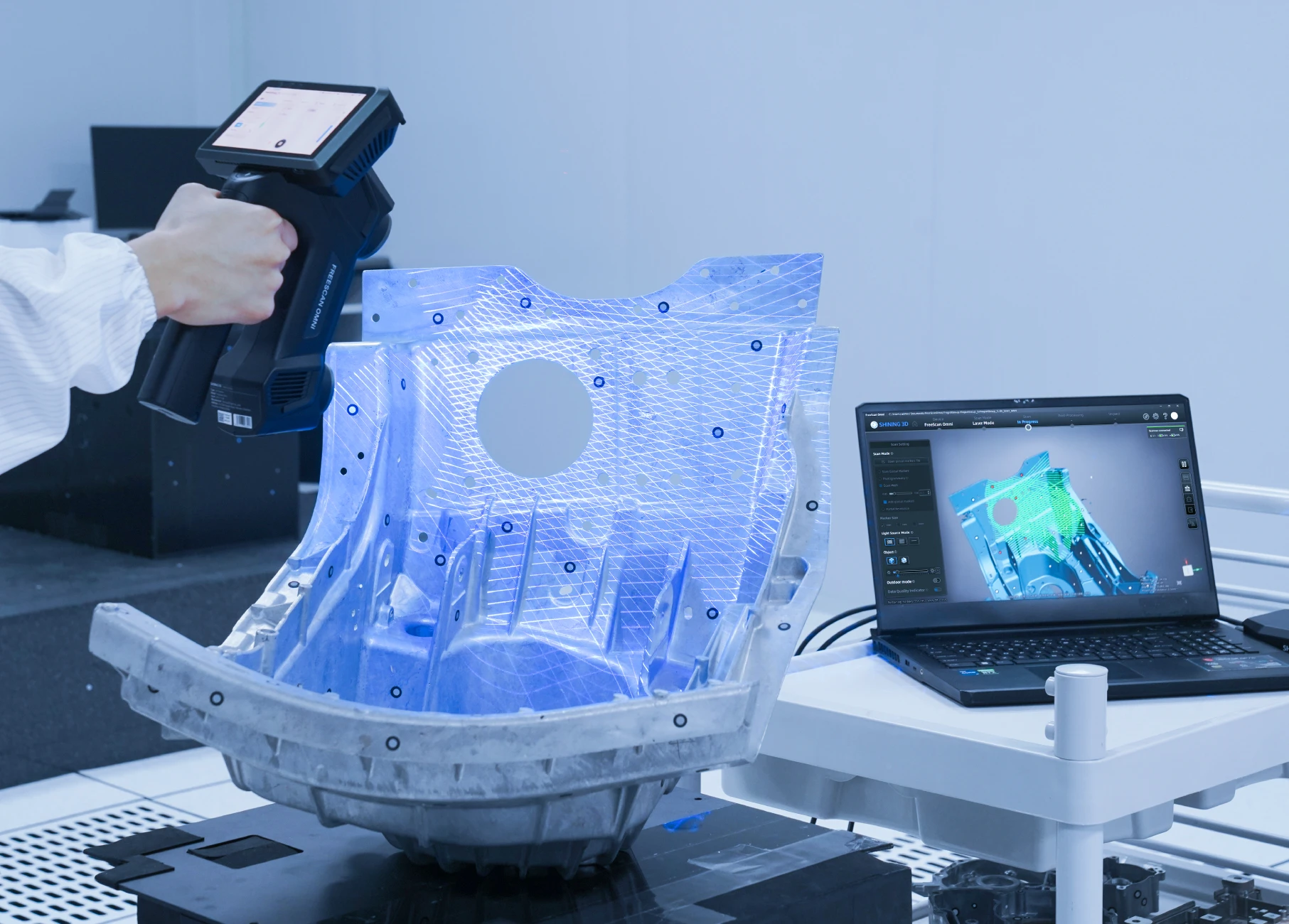 3D scan data processed into engineering deliverables — handheld scanner, part model, and CAD software on laptop