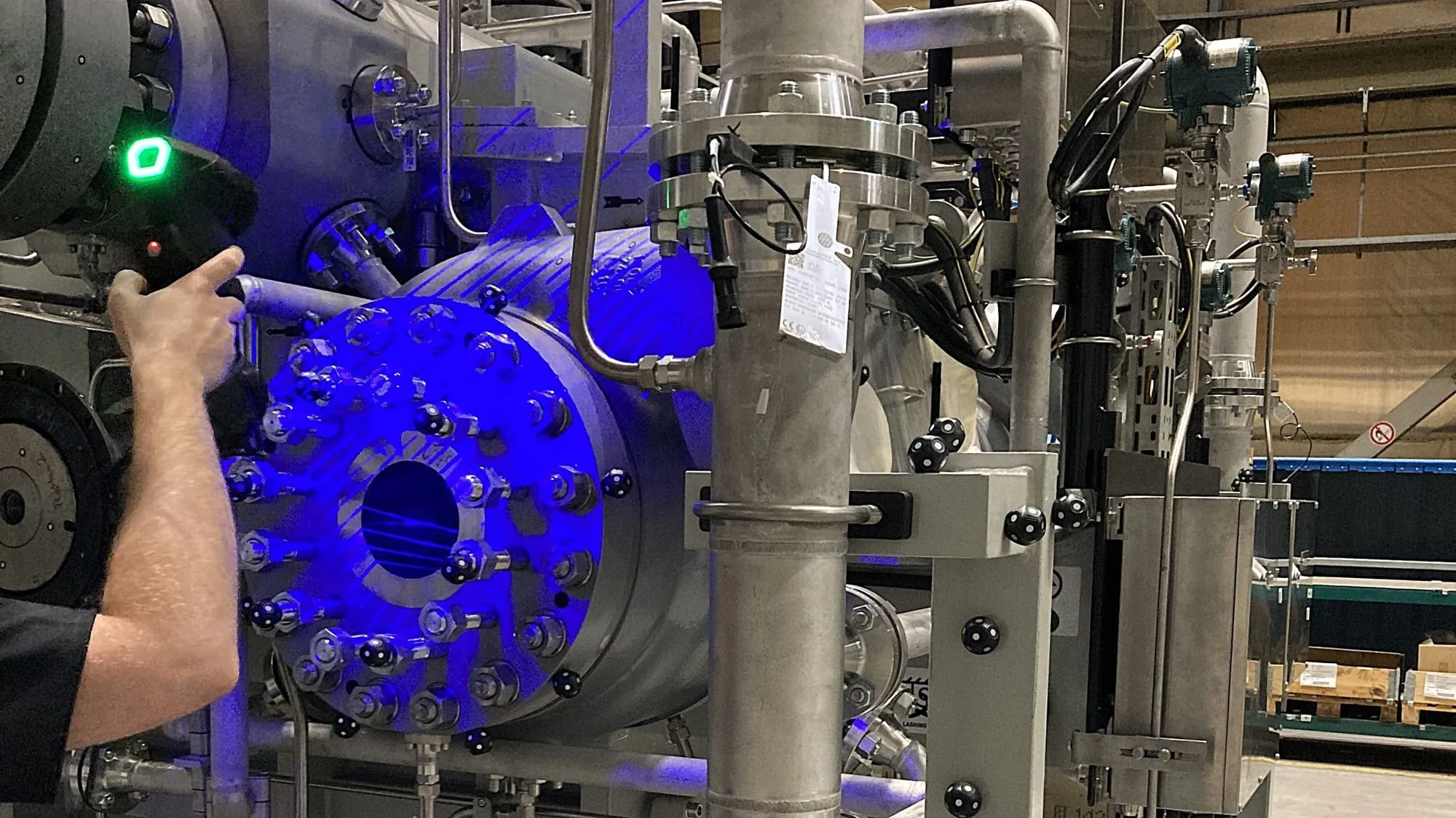 IMS metrology technician operating precision 3D measurement equipment in an industrial facility